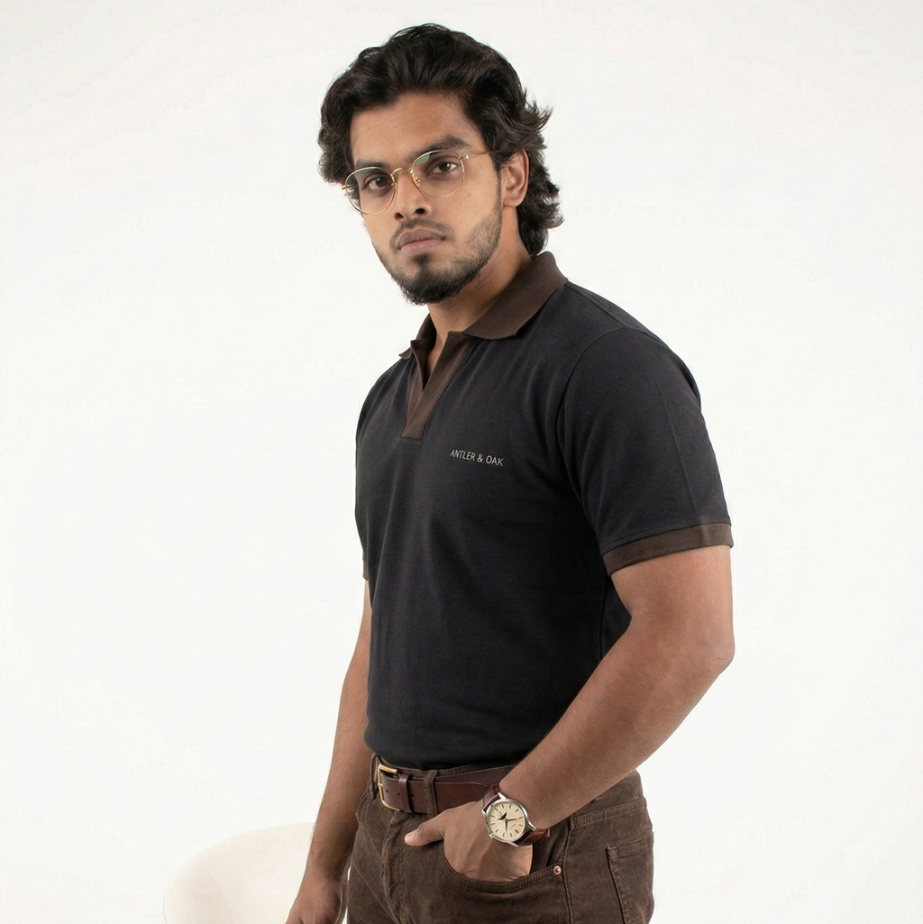 Man wearing a black polo shirt and brown pants on a white backgroun