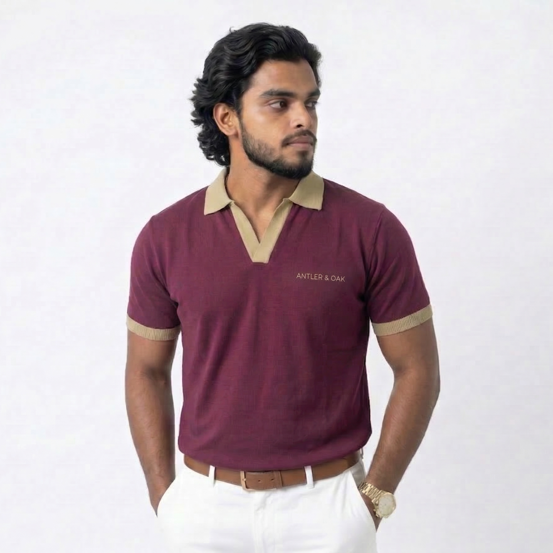 Man wearing a maroon polo shirt with beige accents on a white background