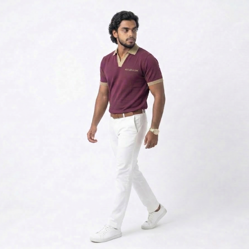 Man wearing a maroon shirt and white pants on a white background